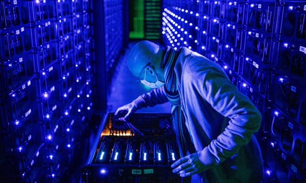 An employee inspects graphics processing units at a crypto farm in Romania last year