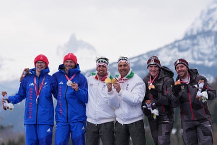 Gold medallist Giacomo Bertagnolli, of Italy, and his guide, Andrea Ravelli, pose flanked by silver medallist Neil Simpson, of Great Britain, and his guide, Rob Poth, and bronze medallist Johannes Aigner, of Austria, and his guide, Nico Haberl, after the men’s alpine combined slalom vision impaired at the 2026 Milano Cortina Winter Olympics