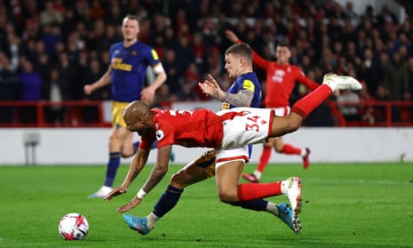 Nottingham Forest’s Andre Ayew goes down under a challenge from Newcastle United’s Kieran Trippier before an offside flag stops play.