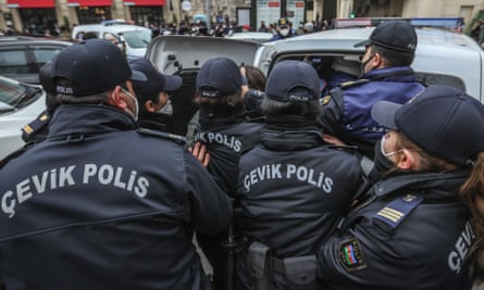 Azerbaijani police officers detain female activists during a protest in Baku on 8 March 2021