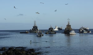 Fishing and tourist boats are anchored in the bay of San Cristobal, Galapagos Islands, Ecuador.