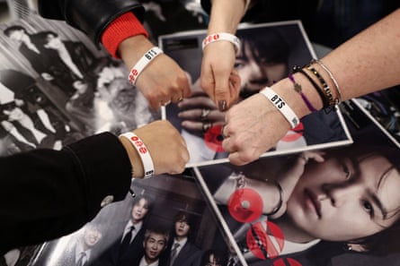 BTS fans pose for pictures as they gather at London’s HMV on Oxford Street for the release of Arirang, in London.