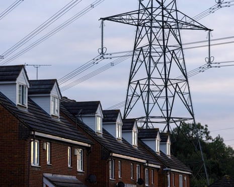 An electricity pylon beyond a row of residential houses near Stevenage, UK, on Wednesday, Sept. 4, 2024