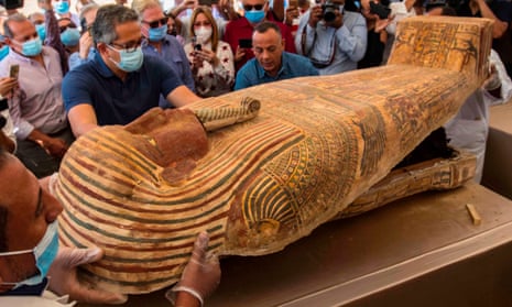 Egyptian minister of tourism and antiquities Khaled Al-Anani, left, opens a sarcophagus excavated earlier this month by the Egyptian archaeological mission working at the Saqqara necropolis.