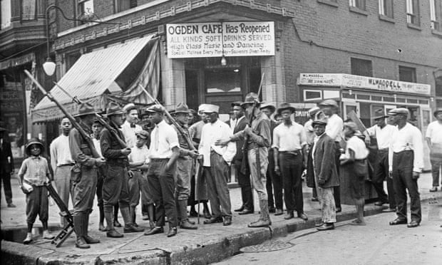 Black citizens and armed National Guard stand in front of a cafe during race riots in Chicago in the ‘red summer’ of 1919.