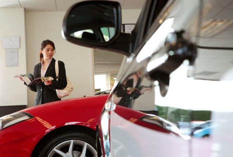 Woman in car showroom