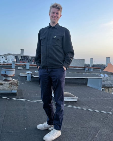 Ben smiling at the camera while standing on a roof
