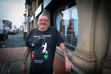 Paul Dagger stands outside the pub smiling.