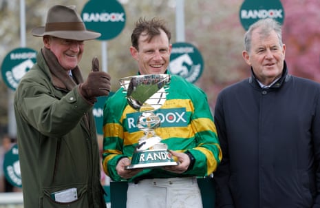 A thumbs up from Willie Mullins as Paul Townend clutches the trophy, alongside J.P McManus.