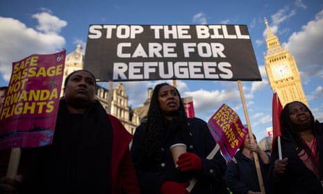 Pro-immigration campaigners protest against the proposed illegal migration bill outside the Houses of Parliament in London.
