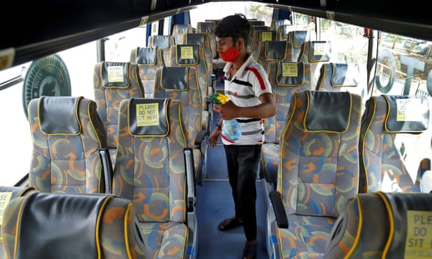A man disinfects seats of an air-conditioned passenger bus after Gujarat state authorities resumed the bus services after easing lockdown restrictions in Ahmedabad, India.