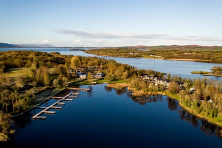 Overhead shot of a blue bay and an island with trees and a few houses
