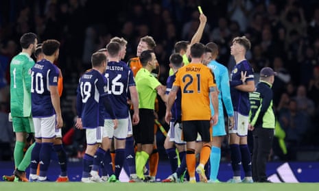 Scotland's Jack Hendry is shown a yellow card by referee Sandro Scharer after the final whistle.