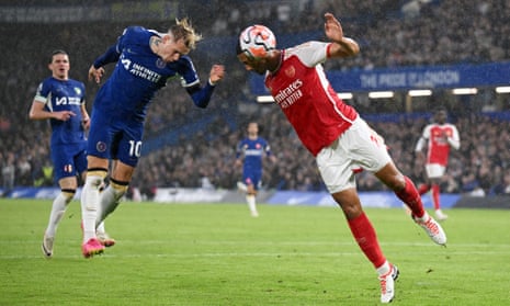 Mykhaylo Mudryk of Chelsea jumps for the ball with William Saliba of Arsenal leading to a possible handball incident for Saliba.
