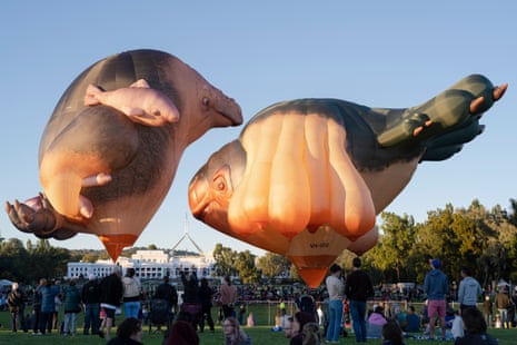 People watch the Skywhale and Skylwahlepapa hover during the world premiere on February 7, 2021 in Canberra, Australia.