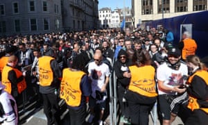 Football fans pass through security gates before the match at the National Stadium in Cardiff.