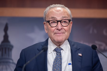 A man in a suit in front of two microphones