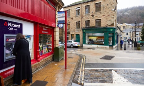 A customer uses the NatWest ATM in Hebden Bridge, West Yorkshire