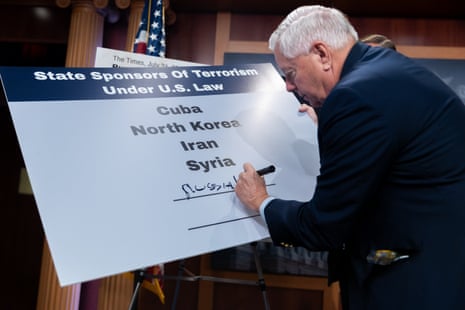Senator Lindsey Graham writes "Russia" on a poster listing state sponsors of terrorism