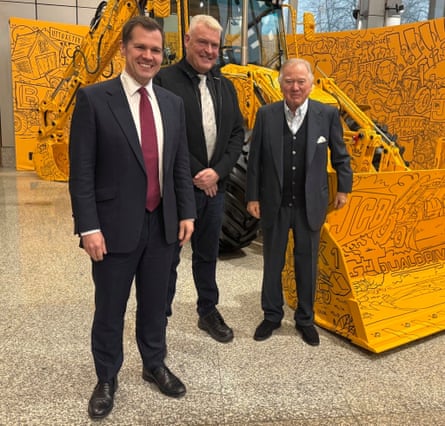 Jenrick, Anderson and Bamford stand in front of JCB machines