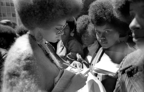 American professor of law and part of the Black Panther Party Kathleen Neal Cleaver signs autographs for a few girls