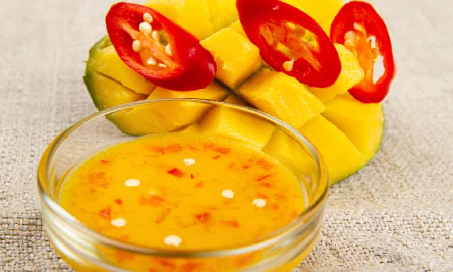 Mango, red pepper and hot sauce in a bowl