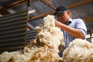Australian Prime Minister Scott Morrison inspects wool during a visit to the Tully family property Bunginderry Station outside Quilpie, Queensland, Tuesday, January 19, 2021.