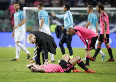 Gordon Strachan comforts Leigh Griffiths after defeat in Slovenia put an end to Scotland’s World Cup dream