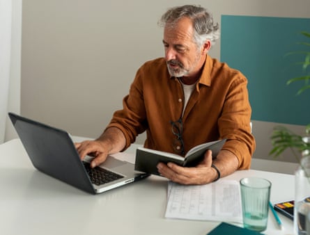 Mature man working using the laptop on the desk