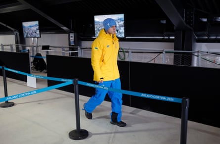 Vladyslav Heraskevych walks to the mixed zone in the finish hut after being disqualified by the IOC for his helmet at the 2026 Winter Olympics
