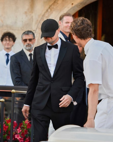 Leonardo Di Caprio wearing a baseball cap low over his face.