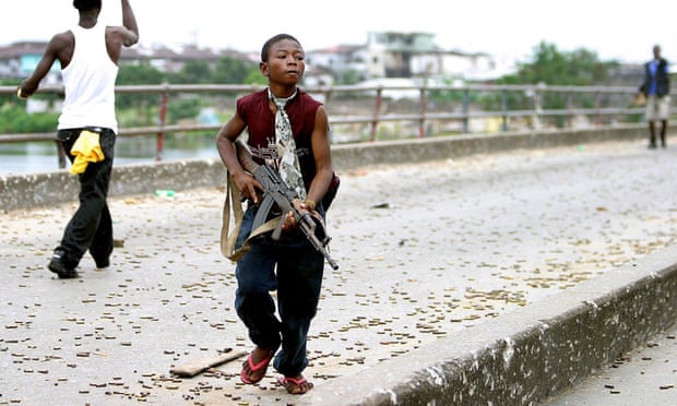 A Liberian child soldier fighting with Charles Taylor’s forces in 2003