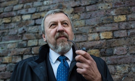 Head and shoulders photo of Andrei Sannikov smoking a pipe