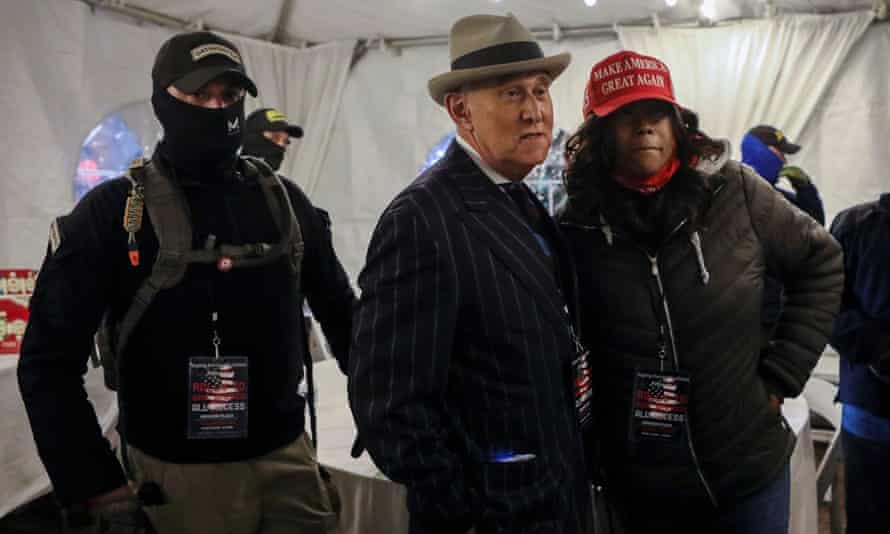 Members of the Oath Keepers militia provide security to Roger Stone at a rally on 5 January.