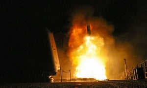 The US Navy cruiser USS Monterey (CG-61) fires a Tomahawk missile at a Syrian target.