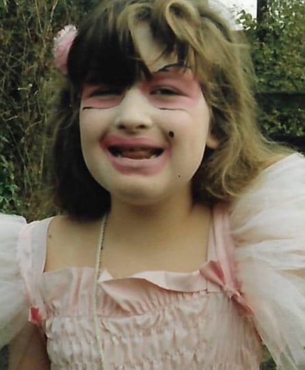Daisy Buchanan wearing a pink party dress and face paint