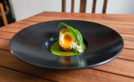 The haddock scotch egg, ‘runny-centred and crisp outside, on an emerald green velouté of wild garlic’: Home, Dumfries.