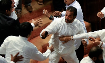 Palitha Thewarapperuma appears to brandish a knife in parliament on Thursday.