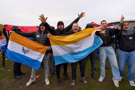Men with orange white and blue flag