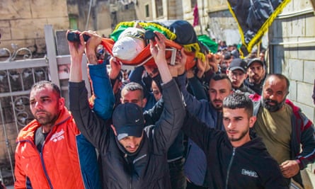 Mourners carry the body of one of three Palestinians who were shot dead by the Israeli army, during their funeral in the town of Jaba, near Jenin, in the occupied West Bank.