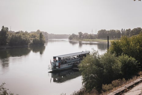A passenger boat docked on a winding river