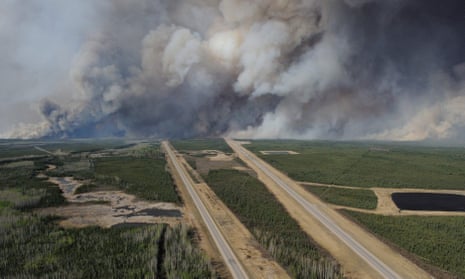 Smoke from fires billows south of Fort McMurray as seen from a helicopter over Highway 63. 