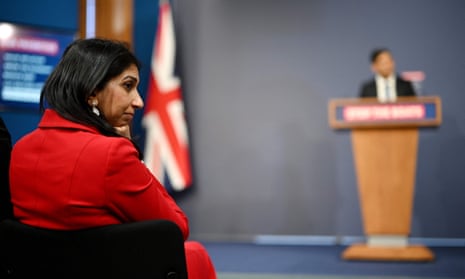 Suella Braverman listens to Rishi Sunak during a press conference on UK immigration policy in Downing this week.