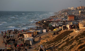 Palestinians in temporary housing in the coastal area of El-Zawaida as Israeli attacks continue on Gaza.