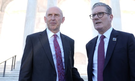 John Healey and Keir Starmer, both wearing a dark suit, purple tie and a white shirt