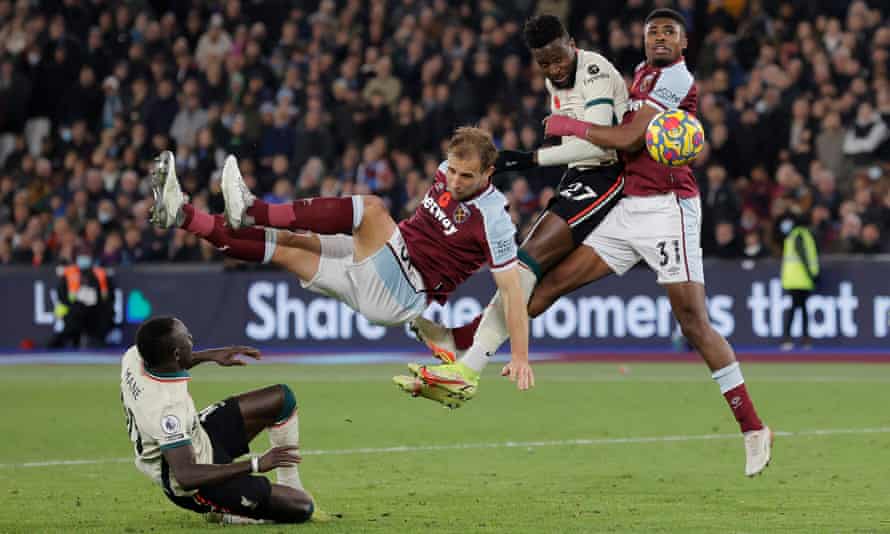 Liverpool’s Divock Origi headers the ball towards goal but his effort was saved by Lukasz Fabianski.