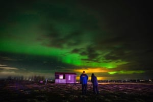 People watch the northern lights from a farm near Selfoss, Iceland