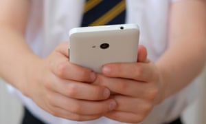 Schoolchild holding mobile phone