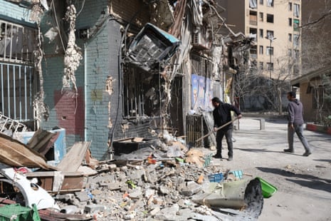 Shop owners clean up the rubble caused by missile explosion in the vicinity of a building in Shahid Borujerdi residential complex in south east Tehran which was heavily struck and destroyed by Israel and U.S. during Operation Epic Fury.