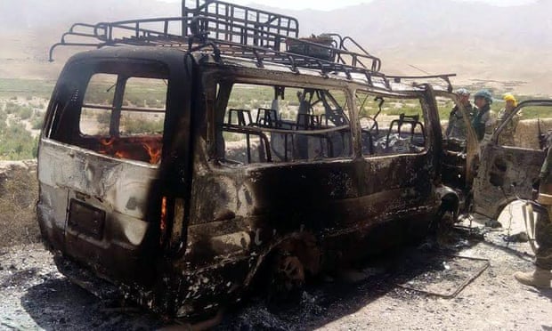 Afghan security officials inspect a van that was believed to have been transporting foreign tourists when it was attacked by militants in Herat province.